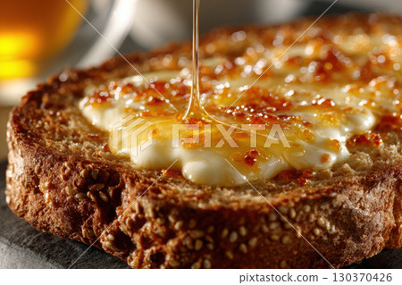 Melting butter glistens on warm, toasted bread slice 130370426