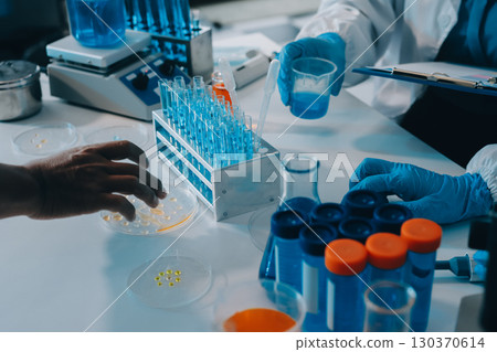 Collaboration, tablet or science with people in lab together for research or development. Innovation, tech and microscope with scientist team in clinical trial for planning or medical investigation 130370614