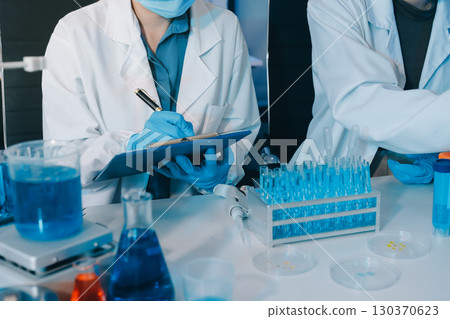 Collaboration, tablet or science with people in lab together for research or development. Innovation, tech and microscope with scientist team in clinical trial for planning or medical investigation Collaboration, tablet or science with people in lab together for research or development. Innovation, tech and microscope with scientist team in clinical trial for planning or medical investigation 130370623