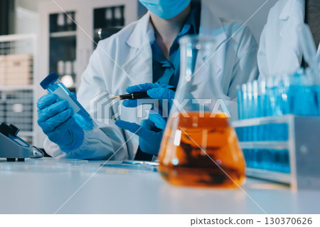 Collaboration, tablet or science with people in lab together for research or development. Innovation, tech and microscope with scientist team in clinical trial for planning or medical investigation 130370626