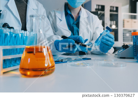 Collaboration, tablet or science with people in lab together for research or development. Innovation, tech and microscope with scientist team in clinical trial for planning or medical investigation 130370627