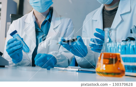 Collaboration, tablet or science with people in lab together for research or development. Innovation, tech and microscope with scientist team in clinical trial for planning or medical investigation 130370628