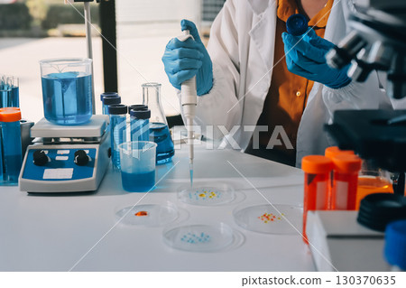 Collaboration, tablet or science with people in lab together for research or development. Innovation, tech and microscope with scientist team in clinical trial for planning or medical investigation Collaboration, tablet or science with people in lab together for research or development. Innovation, tech and microscope with scientist team in clinical trial for planning or medical investigation 130370635