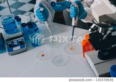 Collaboration, tablet or science with people in lab together for research or development. Innovation, tech and microscope with scientist team in clinical trial for planning or medical investigation Collaboration, tablet or science with people in lab together for research or development. Innovation, tech and microscope with scientist team in clinical trial for planning or medical investigation 130370636