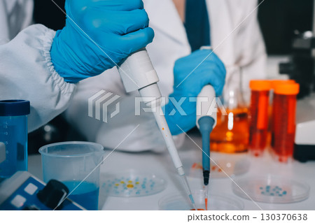 Collaboration, tablet or science with people in lab together for research or development. Innovation, tech and microscope with scientist team in clinical trial for planning or medical investigation 130370638