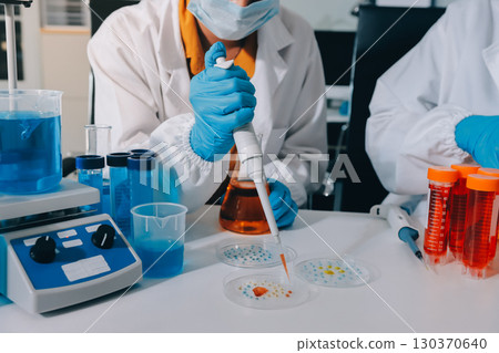 Collaboration, tablet or science with people in lab together for research or development. Innovation, tech and microscope with scientist team in clinical trial for planning or medical investigation 130370640