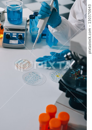 Collaboration, tablet or science with people in lab together for research or development. Innovation, tech and microscope with scientist team in clinical trial for planning or medical investigation Collaboration, tablet or science with people in lab together for research or development. Innovation, tech and microscope with scientist team in clinical trial for planning or medical investigation 130370643