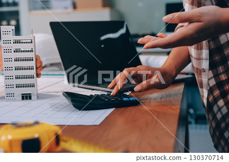 Construction and structure concept of engineer working drawing on blueprint meeting for project working with partner on model building and engineering tools in working site, construction concept. 130370714