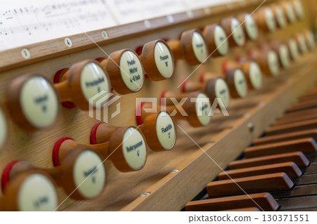 Antique organ keyboard and controls in a Lutheran church. 130371551