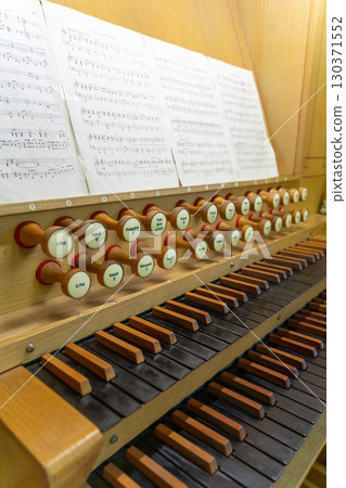 Antique organ keyboard and controls in a Lutheran church. 130371552