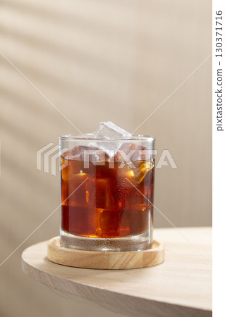 Refreshing iced Americano on a wooden table, cool and energizing. 130371716