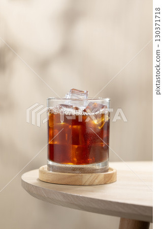 Refreshing iced Americano on a wooden table, cool and energizing. 130371718