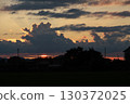 Clouds illuminated by the setting sun 130372025