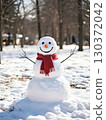 Snowman standing in the winter forest 130372042