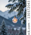 Snowy mountains at dusk and Christmas ornaments 130372043