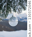 Shining Christmas ornaments on snowy trees 130372046