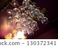 4 glasses hanging from the bar ceiling 130372341