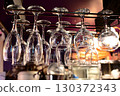6 glasses hanging from the bar ceiling 130372343
