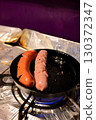 Sausages cooked in an iron skillet 2 130372347