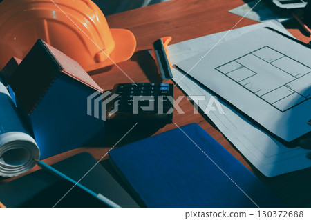 Closeup of team of industrial engineers meeting analyze machinery blueprints consult project on table in manufacturing factory. Working in manufacturing plant or production plant. 130372688