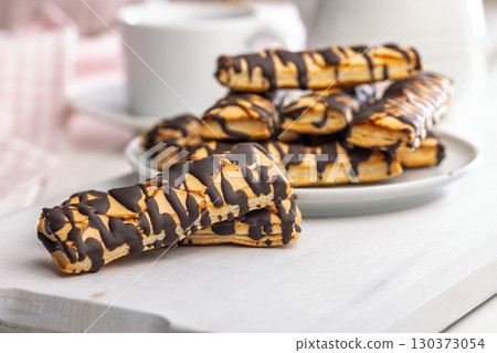 Sfogliatine glassate with chocolate. Italian crispy dessert on white table. 130373054