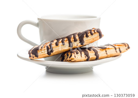 Sfogliatine glassate with chocolate. Italian crispy dessert and coffee cup isolated on white background. 130373059