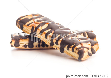 Sfogliatine glassate with chocolate. Italian crispy dessert isolated on white background. 130373062