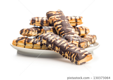 Sfogliatine glassate with chocolate. Italian crispy dessert isolated on white background. 130373064