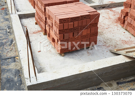 Bricks are neatly stacked on the construction site. Preparing materials for the construction of the building 130373070