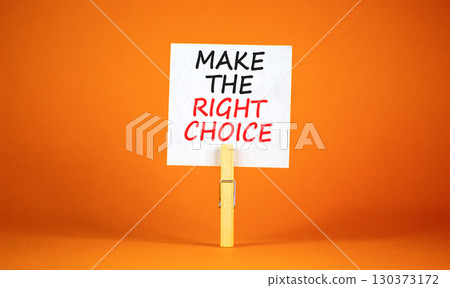 Make the right choice symbol. Concept words phrase Make the right choice on beautiful white paper on clothespin. Beautiful orange paper background. Business Make the right choice concept. Copy space. Make the right choice symbol. Concept words phrase Make the right choice on beautiful white paper on clothespin. Beautiful orange paper background. Business Make the right choice concept. Copy space. 130373172