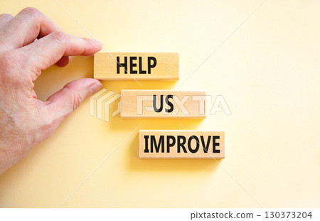 Help us improve symbol. Concept words Help us improve on beautiful wooden blocks. Beautiful white background. Businessman hand. Business motivational help us improve concept. Copy space. Help us improve symbol. Concept words Help us improve on beautiful wooden blocks. Beautiful white background. Businessman hand. Business motivational help us improve concept. Copy space. 130373204