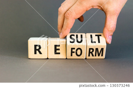 Reform and result symbol. Concept words Reform Result on beautiful wooden block. Beautiful grey table grey background. Businessman hand. Business Reform and result concept. Copy space. 130373246