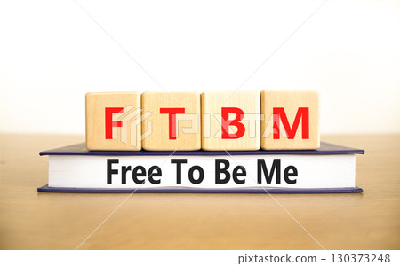 FTBM Free To Be Me symbol. Concept word FTBM Free To Be Me on beautiful wooden blocks and book. Beautiful white background. Business motivational FTBM Free To Be Me concept. Copy space. FTBM Free To Be Me symbol. Concept word FTBM Free To Be Me on beautiful wooden blocks and book. Beautiful white background. Business motivational FTBM Free To Be Me concept. Copy space. 130373248