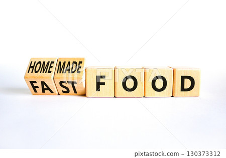 Fast or homemade food symbol. Concept words Fastfood or Homemade food on wooden cubes. Beautiful white table white background. Healthy lifestyle Fast or homemade food concept. Copy space Fast or homemade food symbol. Concept words Fastfood or Homemade food on wooden cubes. Beautiful white table white background. Healthy lifestyle Fast or homemade food concept. Copy space 130373312