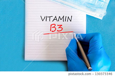 Vitamin B3 niacin symbol. Concept words Vitamin B3 on beautiful white note. Doctor's hand in blue medical glove. Beautiful blue background. Medical healthy lifestyle Vitamin B3 niacin concept. Vitamin B3 niacin symbol. Concept words Vitamin B3 on beautiful white note. Doctor's hand in blue medical glove. Beautiful blue background. Medical healthy lifestyle Vitamin B3 niacin concept. 130373346