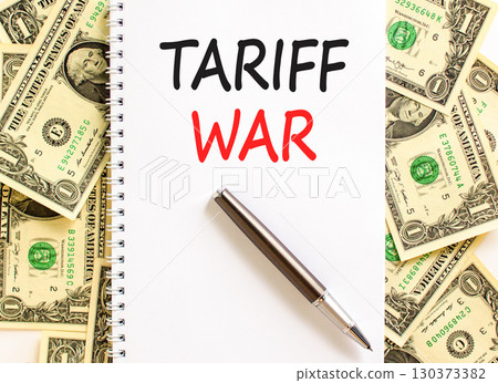 Trade tariff war symbol. Concept word Tariff war on beautiful white note. Dollar bills. Beautiful dollar bills background. Black pen. Business trade tariff wars concept. Copy space. Trade tariff war symbol. Concept word Tariff war on beautiful white note. Dollar bills. Beautiful dollar bills background. Black pen. Business trade tariff wars concept. Copy space. 130373382