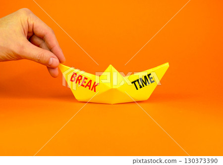 Break time symbol. Concept word Break time on beautiful yellow paper boat. Businessman's hand. Beautiful orange paper background. Business break time concept. Copy space. Break time symbol. Concept word Break time on beautiful yellow paper boat. Businessman's hand. Beautiful orange paper background. Business break time concept. Copy space. 130373390