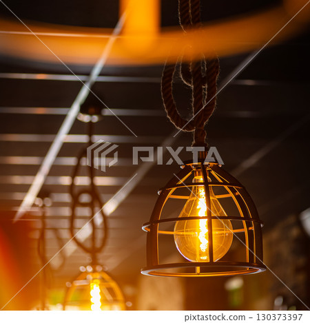 Blinds in a restaurant catching the sunlight with burst light Blinds in a restaurant catching the sunlight with burst light 130373397