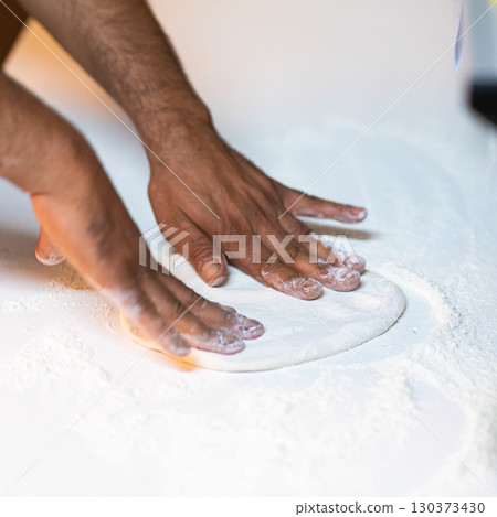 Making pizza dough on board with flour Making pizza dough on board with flour 130373430