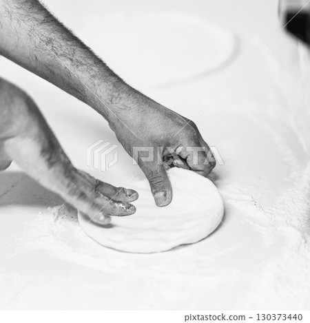 Cook hands kneading dough, piece of dough with white flour. close up on hands Cook hands kneading dough, piece of dough with white flour. close up on hands 130373440