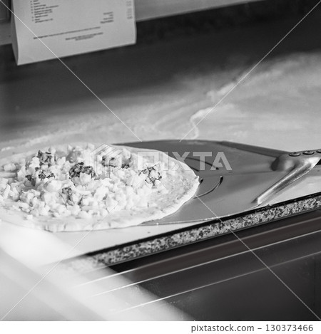 The chef prepares pizza. Raw pizza ready to oven 130373466