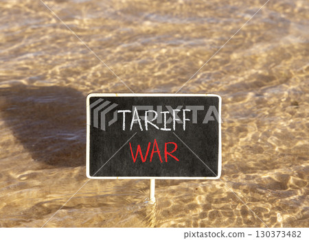 Trade tariff war symbol. Concept word Tariff war on beautiful black blackboard. Beautiful Red sea water background. Black blackboard. Business trade tariff wars concept. Copy space. 130373482