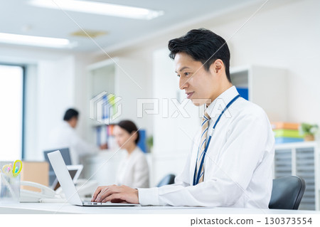 Middle-aged businessman working in the office Middle-aged businessman working in the office 130373554