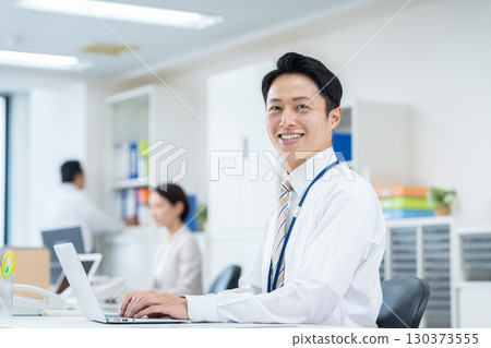 Middle-aged businessman working in the office Middle-aged businessman working in the office 130373555