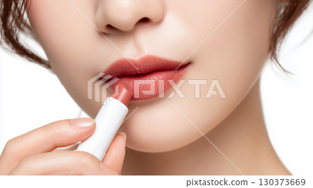 Photo of a woman applying lipstick 130373669