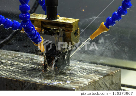 The mold production process by EDM machine working with graphite electrode. The mold production process by EDM machine working with graphite electrode. 130373967