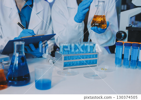 Collaboration, tablet or science with people in lab together for research or development. Innovation, tech and microscope with scientist team in clinical trial for planning or medical investigation Collaboration, tablet or science with people in lab together for research or development. Innovation, tech and microscope with scientist team in clinical trial for planning or medical investigation 130374505