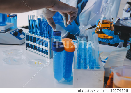 Collaboration, tablet or science with people in lab together for research or development. Innovation, tech and microscope with scientist team in clinical trial for planning or medical investigation 130374506