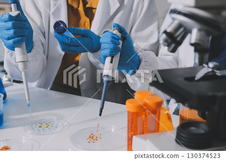 Collaboration, tablet or science with people in lab together for research or development. Innovation, tech and microscope with scientist team in clinical trial for planning or medical investigation 130374523