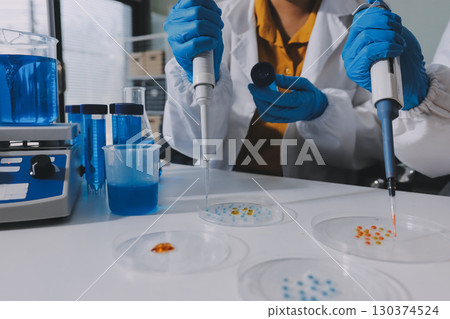 Collaboration, tablet or science with people in lab together for research or development. Innovation, tech and microscope with scientist team in clinical trial for planning or medical investigation Collaboration, tablet or science with people in lab together for research or development. Innovation, tech and microscope with scientist team in clinical trial for planning or medical investigation 130374524